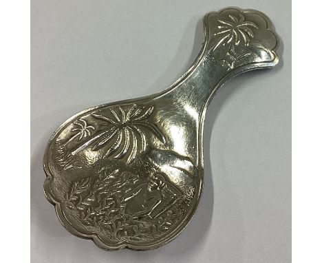 An Indian silver caddy spoon chased with figures. Approx. 14 grams.
