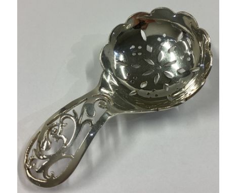 An attractive pierced silver caddy spoon of circular form. Birmingham 1945. By L&L. Approx. 26 grams.
