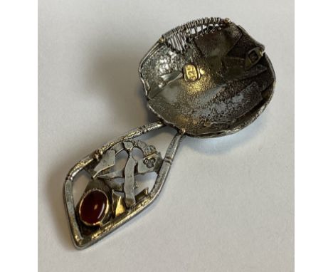 A large heavy stylised silver caddy spoon with gold mount. London 2012. NHG. Approx. 41 grams.