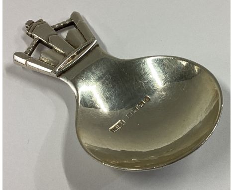 R E STONE: A heavy circular caddy spoon of typical form. London 1915. Approx. 21 grams.