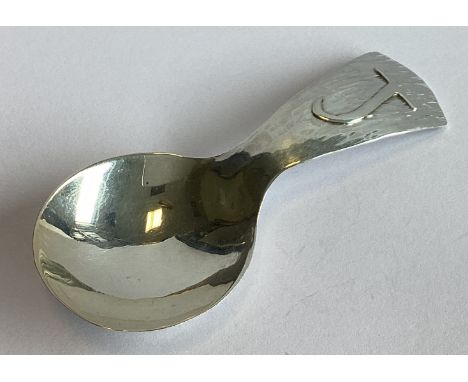 A textured silver caddy spoon. London 1968. By WEK. Approx. 17 grams.