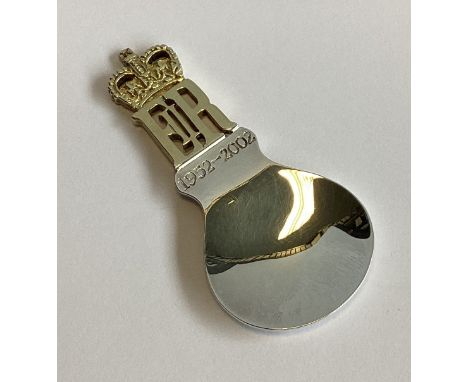 A E JONES: A good commemorative silver and silver gilt caddy spoon. Birmingham. Approx. 29 grams.