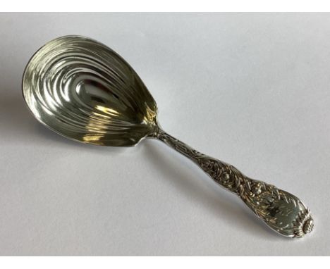 TIFFANY & CO: An attractive silver caddy spoon with floral decoration. Approx. 33 grams.