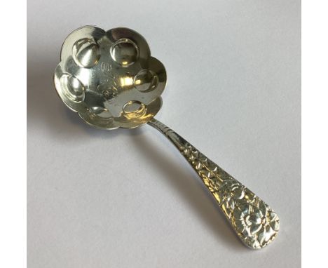 A Continental silver caddy spoon decorated with floral handle. Approx. 16 grams.
