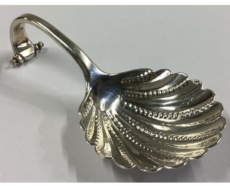 A good Georgian silver scroll back caddy spoon with fluted bowl. London. By IP. Approx. 29 grams.