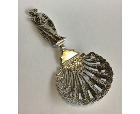 A heavy chased and pierced silver caddy spoon with figural handle. London 1900. By TW. Approx. 46 grams.