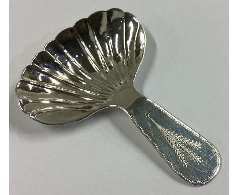 DUBLIN: An attractive Irish silver caddy spoon with wheatsheaf decoration in the Georgian style. By WE. Approx. 15 grams.