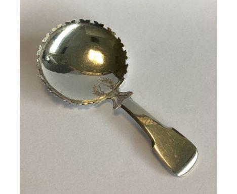 A good heavy silver fiddle pattern caddy spoon with shaped border. London. By TJ. Approx. 16 grams.