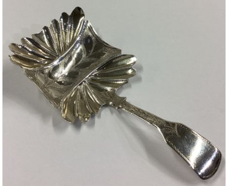 An unusual shaped silver caddy spoon with bright-cut decoration. Birmingham 1830. By JC. Approx. 5 grams.