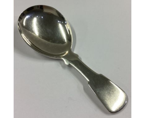 A heavy Georgian silver fiddle pattern caddy spoon. Punched verso. By JS. Approx. 18 grams.