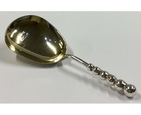 A good silver and silver gilt caddy spoon of tapering form. Birmingham. By H&T. Approx. 12 grams.