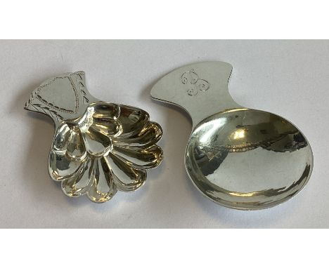A heavy Continental silver caddy spoon in the Georgian style together with another similar example. Approx. 32 grams.