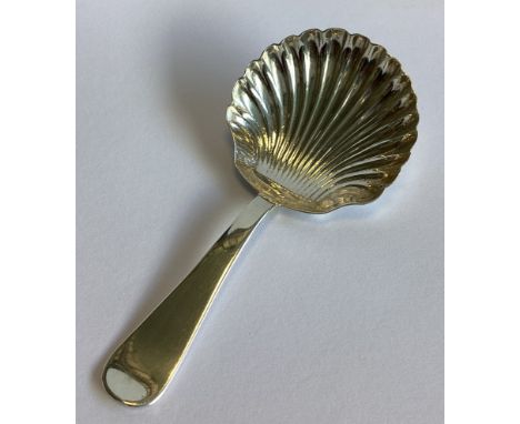 A large silver caddy spoon with fluted bowl in the Georgian style. Sheffield 1930. By CWS. Approx. 20 grams.