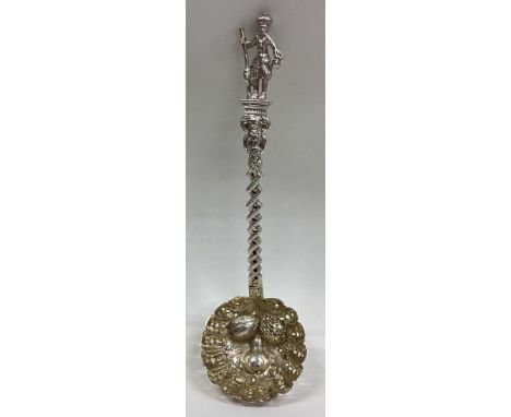 EDINBURGH: A chased silver and silver gilt sifter ladle with fruit decoration. By TC. Approx. 47 grams.