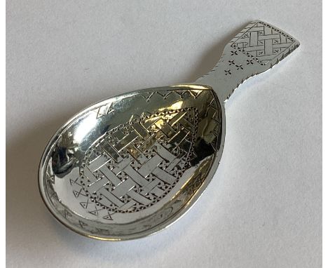 LIBERTY & CO: An engraved silver caddy spoon of stylised form. Birmingham 1911. Approx. 30 grams.