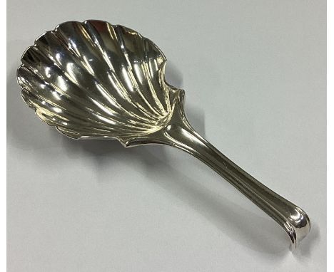 A Georgian silver caddy spoon of fluted design. London. By TI. Approx. 11 grams.