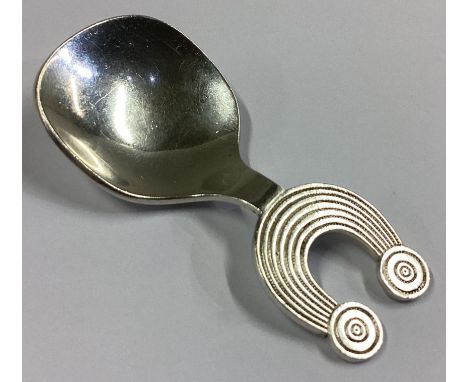 DUBLIN: A heavy Irish silver caddy spoon of stylised form. By OC. Approx. 33 grams.