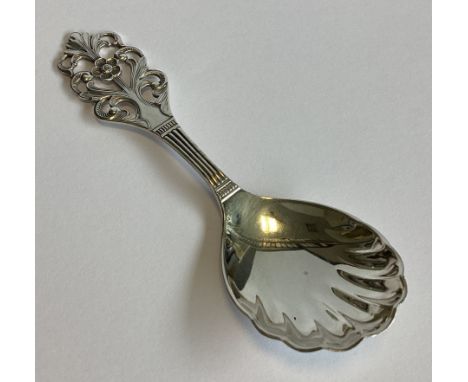 A pierced Norwegian silver caddy spoon with fluted decoration. Approx. 21 grams.