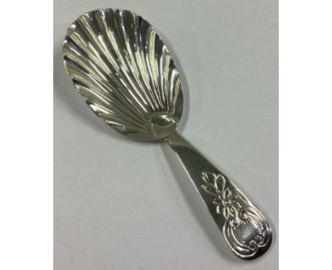 A Georgian silver caddy spoon with fluted bowl and floral decoration. London 1810. By SH. Approx. 8 grams.