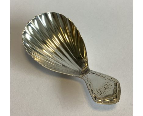 A small fluted silver caddy spoon with bright-cut decoration. London 1794. By HS. Approx. 10 grams.