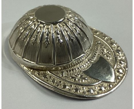 An Edwardian silver caddy spoon in the form of a jockey's cap with vacant cartouche. Sheffield. By FH. Approx. 12 grams.