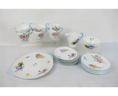 A Shelley tea service in the Wild Flowers pattern comprising six cups, six saucers, six side plates, sugar bowl, milk jug and