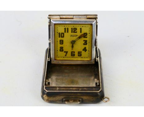 A white metal cased Tissot purse clock, the signed square dial with Arabic numerals, case stamped 0.935. [W]Condition Report: