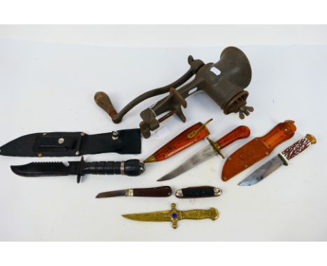 A collection of knives and a vintage mincer. [W]Note: This lot is not for sale to people under the age of 18. By bidding on t
