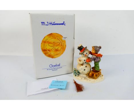 Goebel - A large Hummel group entitled Making Friends depicting a boy building a snowman, approximately 16 cm (h), contained 