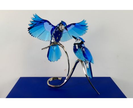 Swarovski - A boxed crystal group from the Paradise Crystal Birds collection depicting two Blue Jays on white metal stand, ap