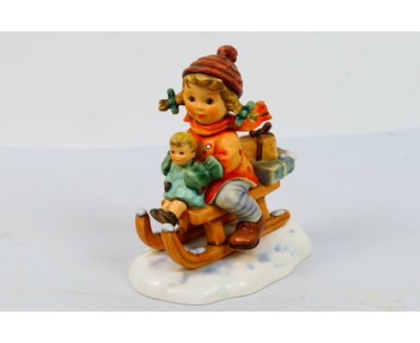 Goebel - A First Issue Hummel figure from 1997, Christmas Delivery depicting a young girl on a sledge with wrapped presents, 
