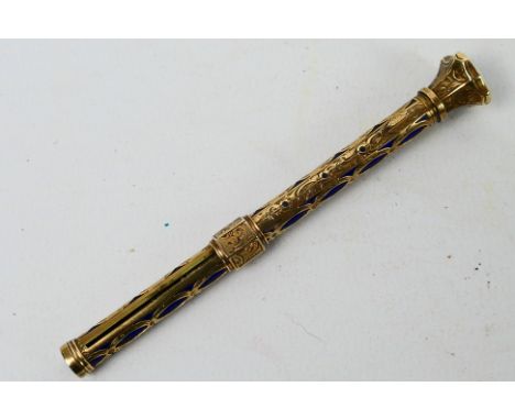 A yellow metal and blue enamel propelling pencil, approximately 16 grams. [W]Condition Report: Pencil extends, lead does not 