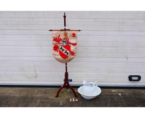 A heraldic tapestry on display stand, 143 cm (h), a wash bowl and jug and Old English Sheepdog figures. [3]. [W]