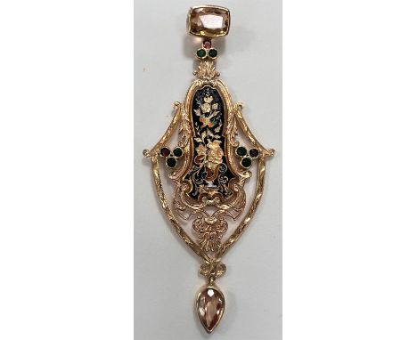 An elaborate pendant in the Spanish style with black enamel decoration, set with Topaz, Ruby and Emeralds, tests as 18ct, 8.9