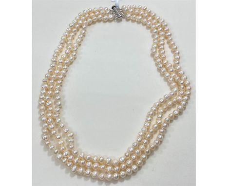 A Kaori triple pearl necklace (6.5 x 5.5mm) and a similar pearl bracelet (10mm x 9mm); a Sterling silver ring set with freshw