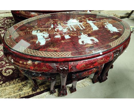 A modern Chinese coffee table with oval top, red lacquered and raised mother-of-pearl figures; etc.; a smaller table 