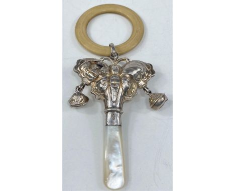 A hallmarked silver teething ring in the form of a butterfly with bells and mother-of-pearl handle 