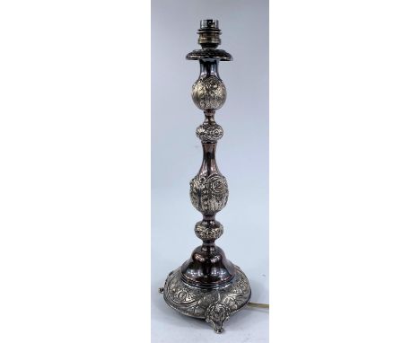 A hallmarked silver candlestick, turned and knopped with embossed decoration, on 3 feet, London 1909, 19 oz gross, height 42c