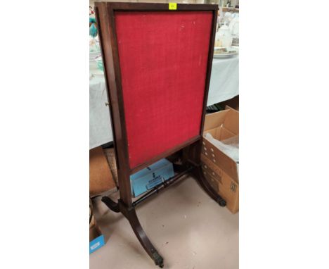 A 19th century mahogany firescreen with pull out side panels, on splay feet with brass castors 