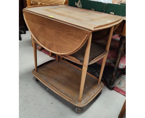 An Ercol light elm 2 tier tea trolley with drop leaves 