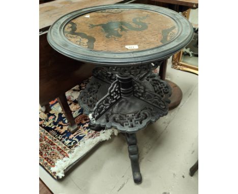 A late 19th century Chinese unusual occasional table, the circular burrwood inset top decorated with a dragon, having pierced