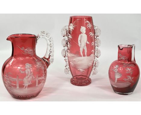 A Mary Gregory cranberry glass vase decorated with hoop and stick, height 23cm (very minor rim chips); 2 similar jugs, height