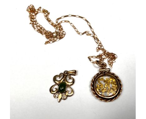 A rope twist circular pendant set yellow metal shavings, stamped '12KT' on 9 carat hallmarked gold fine chain, 2.4 gm; an Art