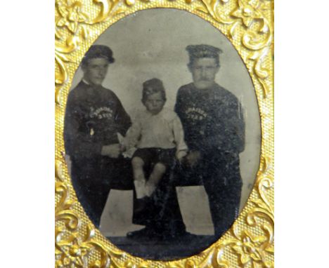 A small ambrotype showing what is believed to be the Tsar's son Alexei Nikolaevich sitting between two sailors on the royal y