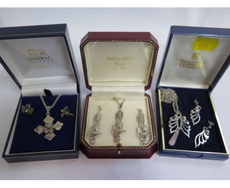 A collection of five sets of silver jewellery, some gem set, cased, each set has a necklace or pendant on a neck chain and a 