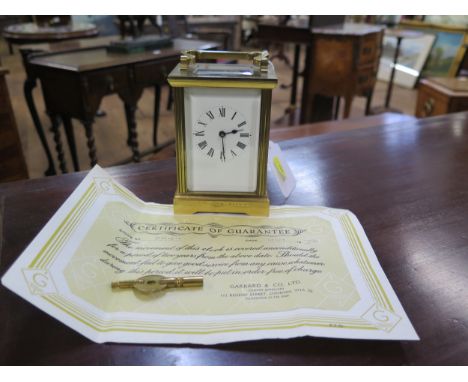 A carriage clock. In a Corniche case. Together with a key and a guarantee from Garrards 