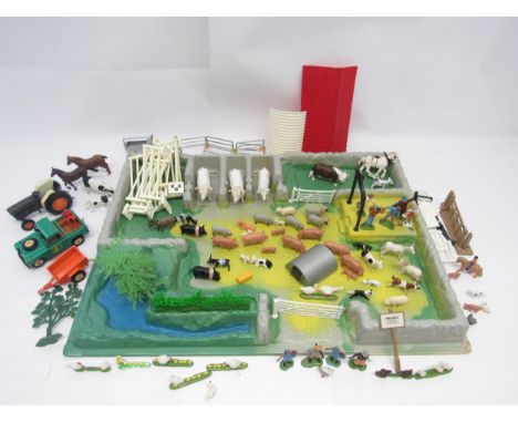 A Britains model farmyard play base, together with Britains diecast Land Rover and trailer and Ford 6600 tractor, farm animal