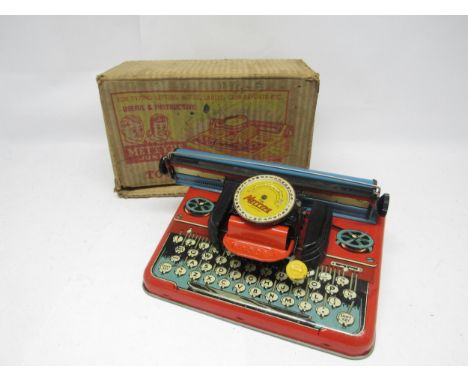 A boxed Mettype Junior tinplate typewriter