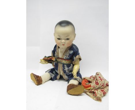An early 20th Century Armand Marseille bisque head East Asian baby doll, with black painted hair, brown glass sleeping eyes, 