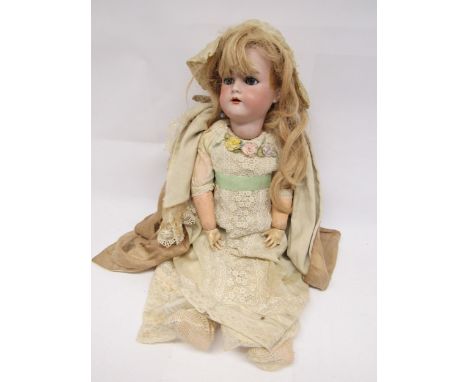 An early 20th Century Simon &amp; Halbig / Kammer &amp; Reinhardt bisque head girl doll, with blonde wig, striated blue glass